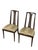 A distinctive pair of vintage mid-century modern dining chairs featuring exceptionally tall sculpted wood backs, narrow...