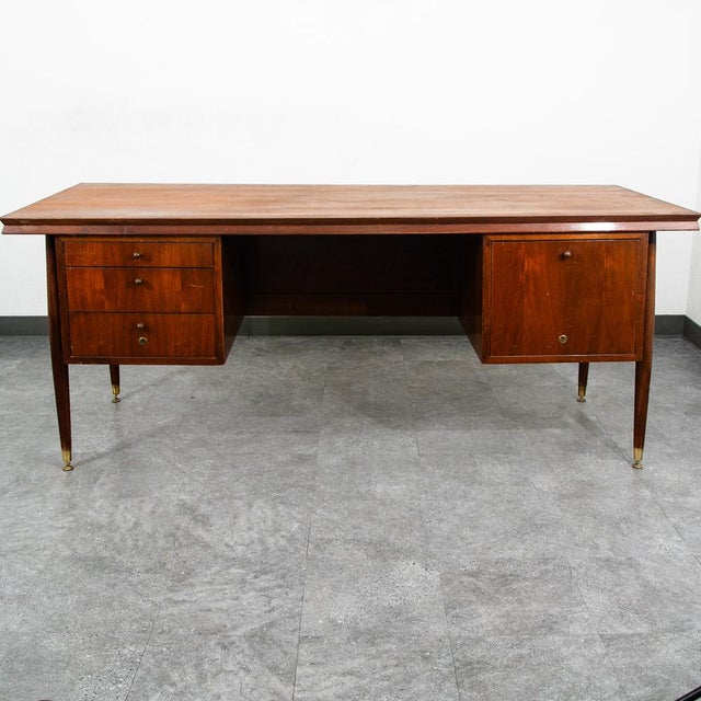 Sculptural executive desk in walnut w/ cane front panel. The top surface has been refinished completely. unstamped...