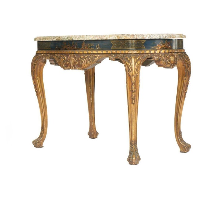 French Chinoiserie Carved Marble Top Center Table. Serpentine marble top rests above a conforming giltwood base. The apron...