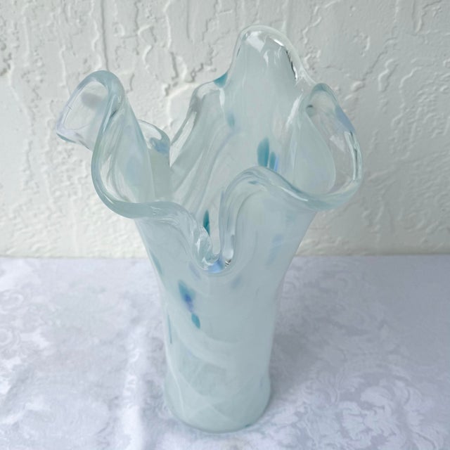 An elegant Italian hand-blown art glass vase crafted in the Murano tradition, featuring a graceful freeform silhouette...