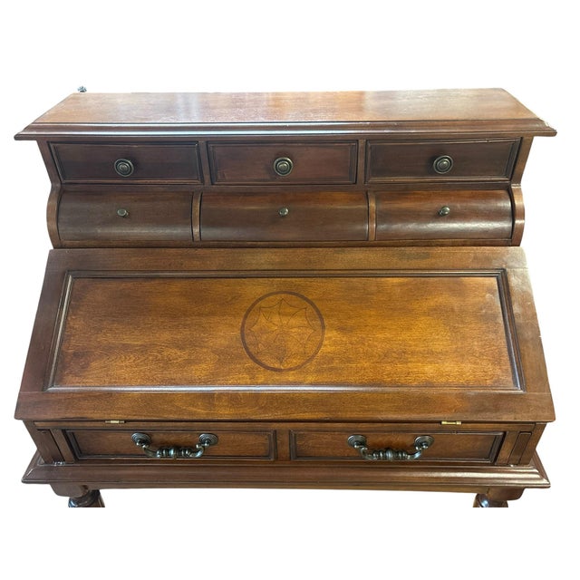 Elegant and exceptionally functional, this traditional secretary desk features a beautifully finished cherry-toned case...