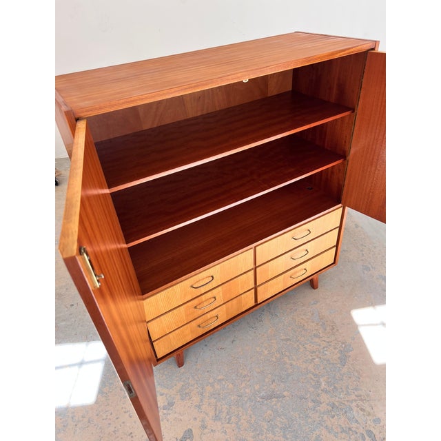 This linen cupboard, designed as a classic gentleman's chest by Gebr. Lübke, is an outstanding example of the high-quality...