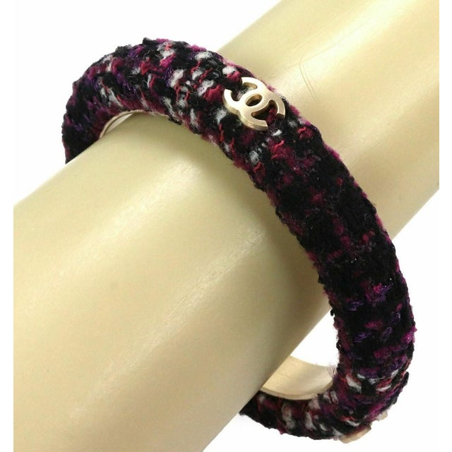 This chic authentic Chanel bangle from the Tweed collection features a striking mix of dark and light purple tones blended...