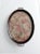 This antique Victorian serving tray features an elegant oval wooden frame with brass handles and a floral textile base...