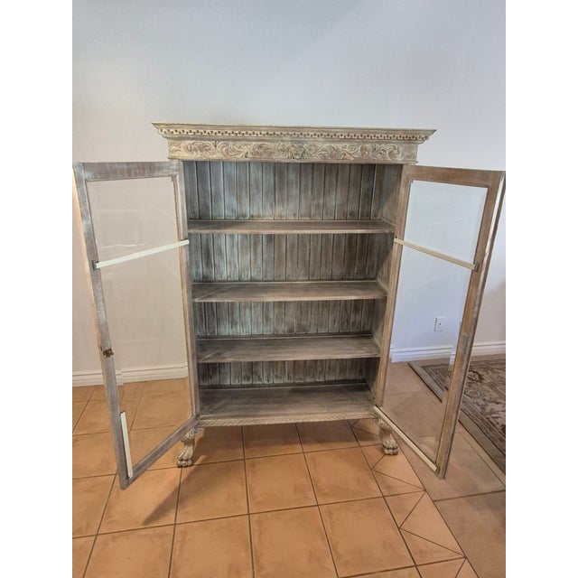 This piece is a 19th-century European Neoclassical display cabinet or bookcase, heavily styled in the Liegoise (Belgian)...