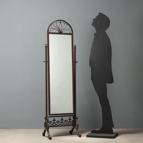 Wrought iron psyche. Tilting mirror supported by two square columns resting on curved feet with curled workmanship. Italy,...