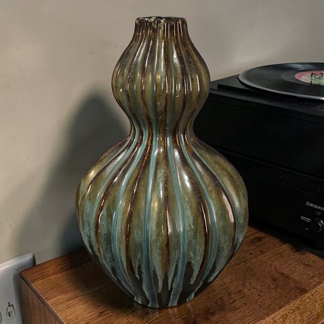 This vintage glazed pottery double gourd ribbed vase features a unique design in earth tone colors, typical of Mid-Century...