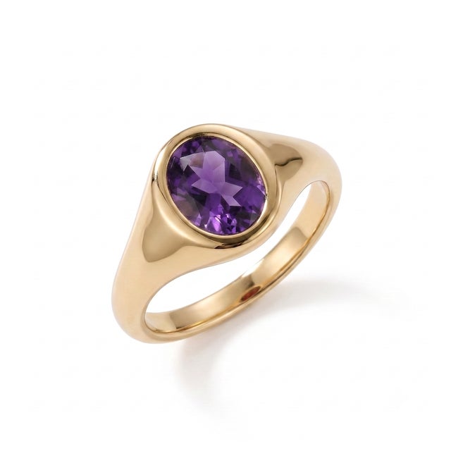 Designed with timeless simplicity, this elegant Natural Amethyst Signet Ring showcases a stunning 7 x 5 mm oval-cut...