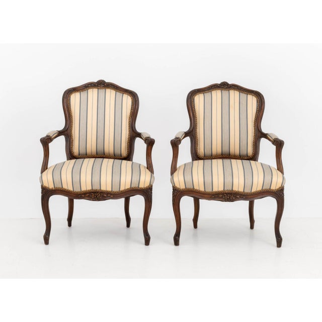 Pair of Louis XV Style Walnut Fauteuils, with blue and off-white striped linen upholstery on cabriole legs. 36.5" H x 26"...