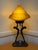 Nuart double nude figure lamp with frosted glass spiral lampshade and bronze finish. Lamp has been re-wired and is in...