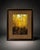 Decorative framed autumn forest print featuring bright yellow trees, warm brown matting, and a classic dark wood-tone...