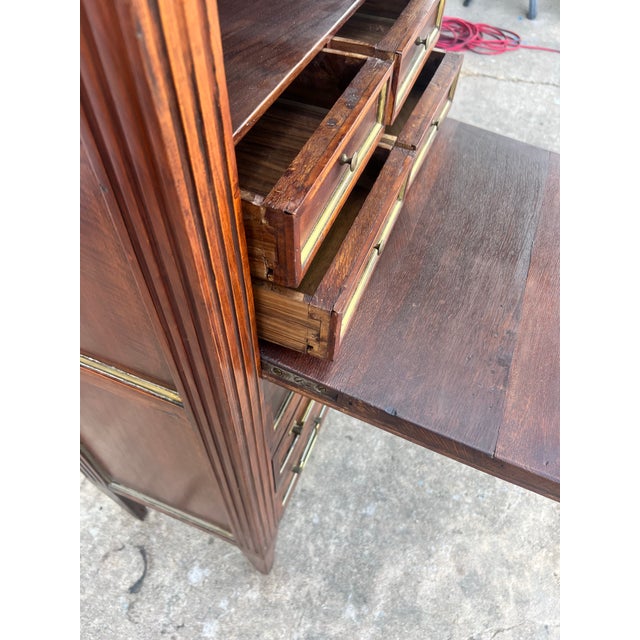 Elegant 19th-century Louis XVI secrétaire crafted in rich mahogany veneer with beautiful figured grain. Featuring a fall-...