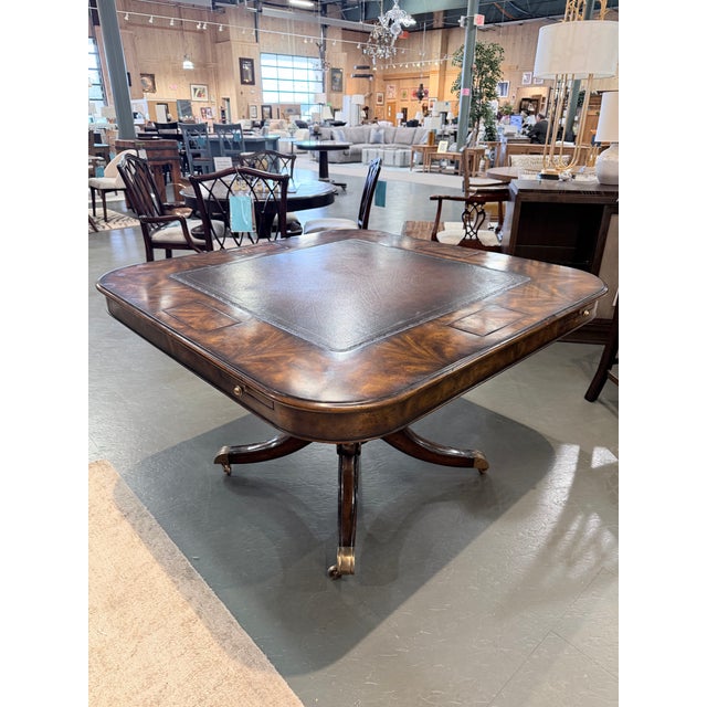 A richly appointed burled walnut game table in the Regency manner, distinguished by its striking veneer work and...