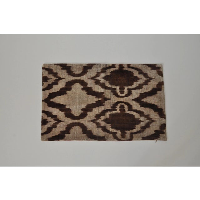 This brown accent pillow with an interesting design pattern is handwoven in silk velvet. Reverse side is in a silk ikat....