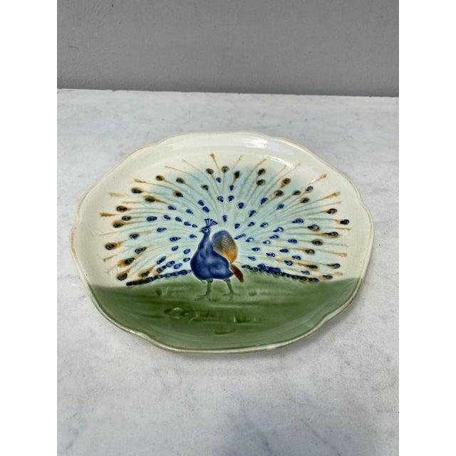 Majolica plate with a peacock signed Hippolyte Boulenger Choisy le Roi, circa 1890. The manufacture of Choisy le Roi was...