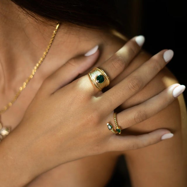 Bring timeless elegance to your style with the Emerald Teardrop Glow Gold Adjustable Ring. Featuring two stunning...