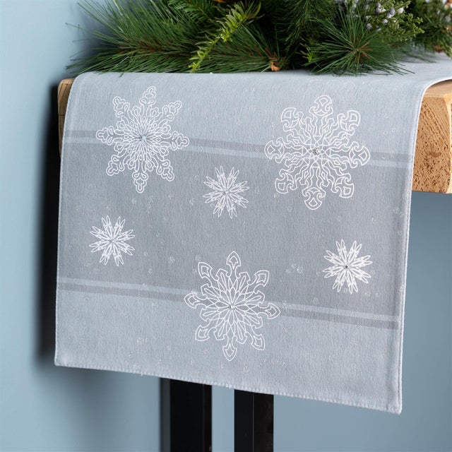 Transform your holiday dining experience with this Embroidered Snowflake Table Runner. Designed with delicate snowflakes...