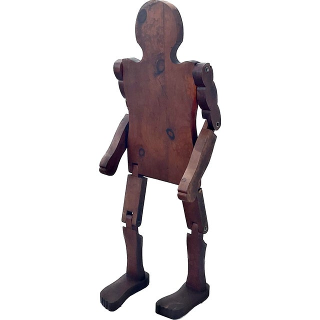 Mid-century wooden, hand-carved articulated mannequin folk art sculpture in a child size. Arms, hands, legs, and feet are...
