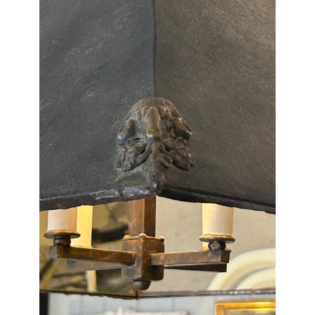 Handsome rustic masculine graphite metal light fixture having blackened exterior with decorative iron ram’s heads in the...