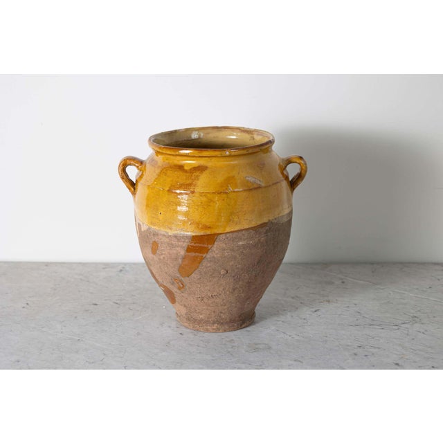 This 19th-century Spanish pottery jar is a beautiful example of rustic Mediterranean craftsmanship. Handcrafted from...