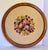 Here is a vintage hand-stitched floral needlepoint wall hanging presented in a handsome round wood frame. Featuring a...