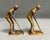 A vintage pair of brass golf player bookends. The mid-century set displays detailed design in an aged gold-tone finish....