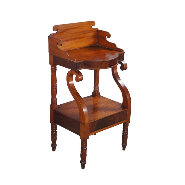 Antique two tier wash stand / parlor side table / nightstand. Made of flame mahogany featuring American Empire styling...