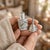 Mid-century Mexican vanity set: a miniature glass perfume bottle in a hand-cut sterling overlay sleeve with leaf motifs...