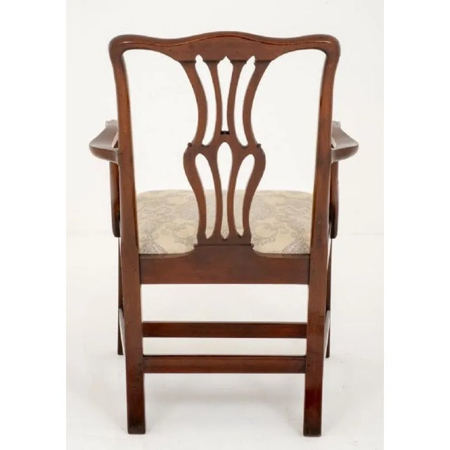 Georgian style mahogany open elbow chair. Having square legs with an "H" frame (for extra strength) circa 1860. Featuring...