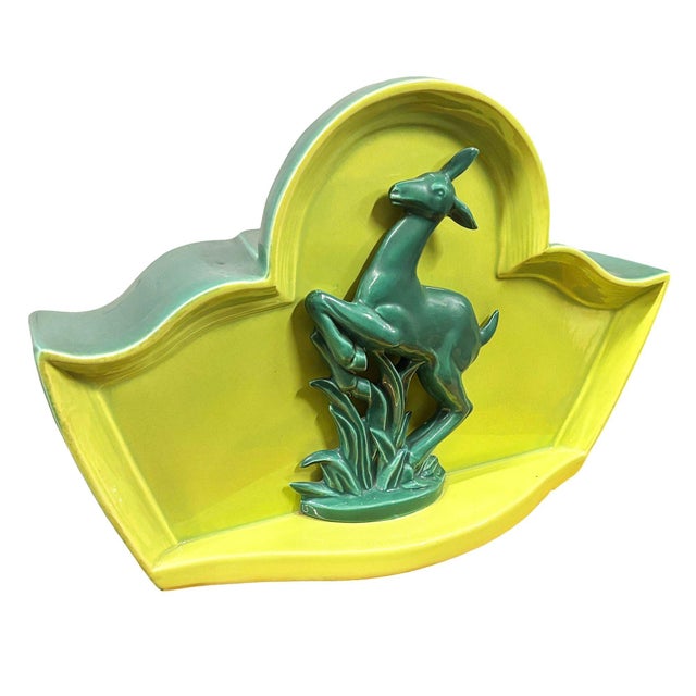 Original Mid-Century Modern green ceramic deer TV lamp with designed with a leaping gazelle or deer figurine against a...