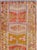 This mid-20th-century Turkish Anatolian runner presents a lively vertical sequence of geometric medallions framed by broad...
