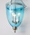 A single hanging glass pendant in soft aqua blue with nickel hardware. Features three interior arms for bulbs and hangs...
