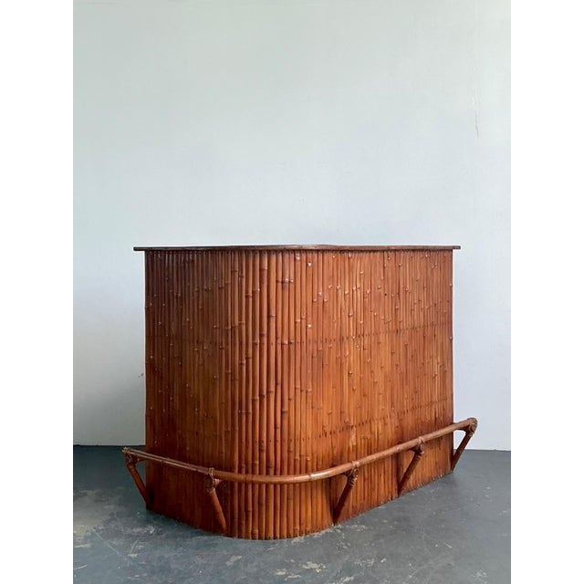 This exceptional vintage curved bamboo Tiki bar embodies the relaxed glamour and escapist spirit of mid-century tropical...