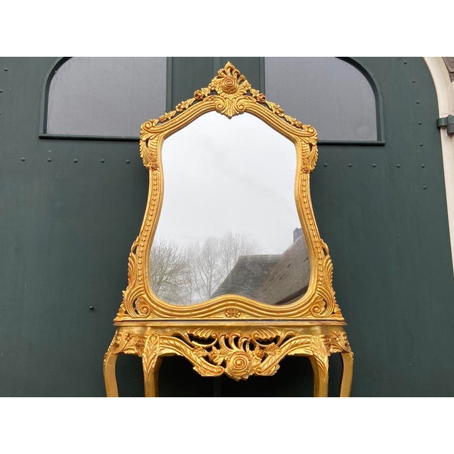 A magnificent Mid 20th-century French console table and mirror set, combining Louis XVI symmetry with the flowing ornament...