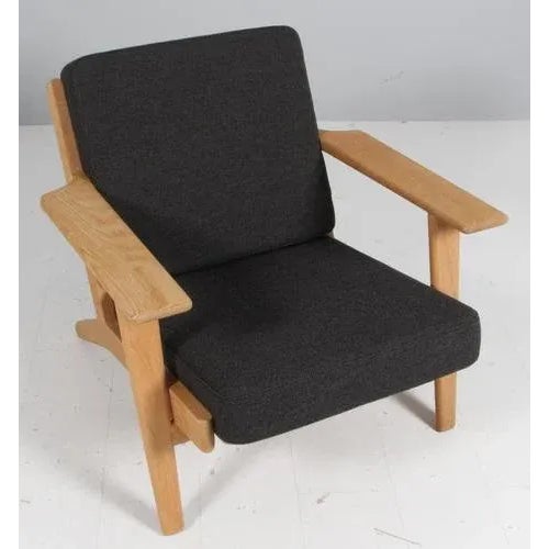 Hans J. Wegner lounge chair made of solid soap treated oak. New upholstered with two tone grey Hallingdal wool from...