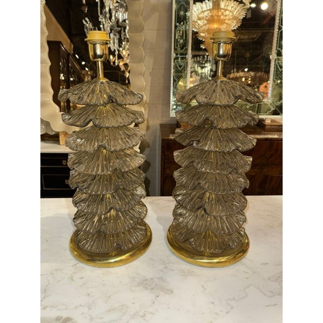 These lamps are a unique addition to any space, featuring intricate ruffle designs created with Murano Fume' Glass. The...