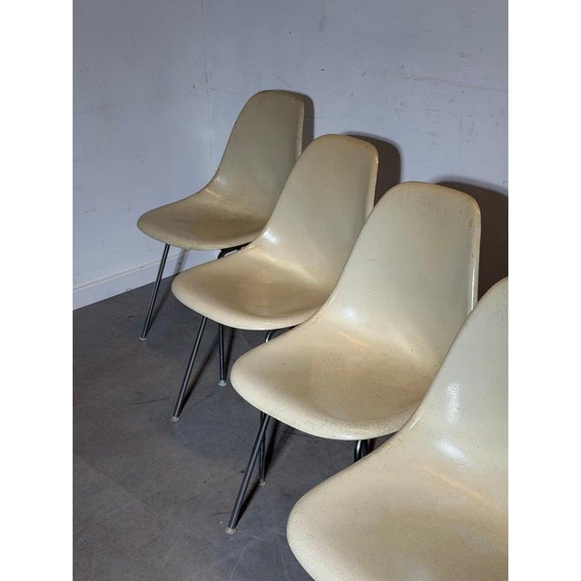 Authentic set of four vintage Herman Miller fiberglass side chairs, designed by Charles & Ray Eames. These iconic mid-...