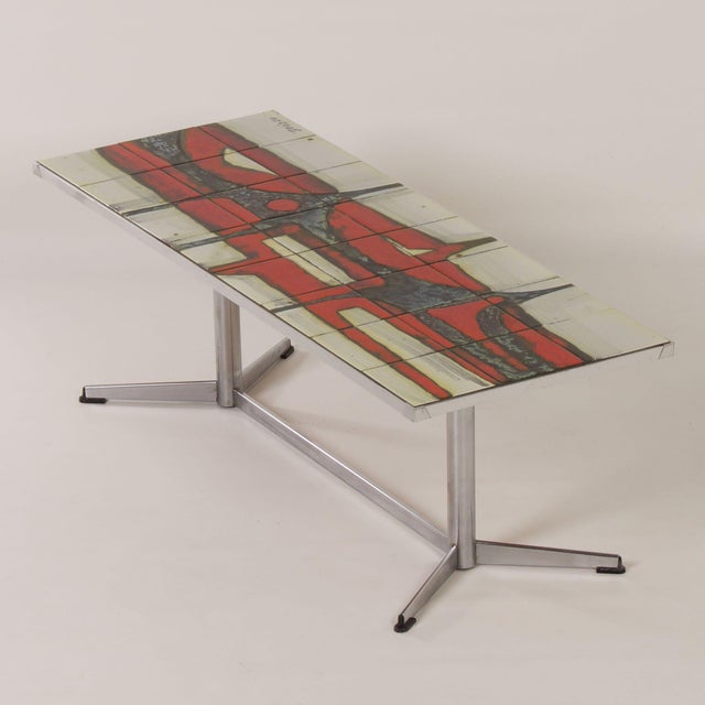 Mid-Century coffee table with ceramic tile table top made at Denisco, Belgium ca. 1960s. The frame/base is made of chrome-...