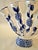 Celebrate timeless elegance with this **Vintage Bella Casa by Ganz Five Finger Blue & White Bud Vase**, a beautifully...