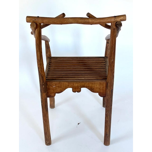 Unusual handmade antique chair with slat seat. No makers mark. Some age wear. Pictured.