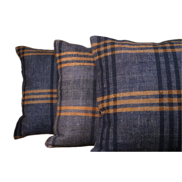 Beautiful set of three vintage handwoven pillow covers, featuring rich indigo tones with warm mustard stripes. These...