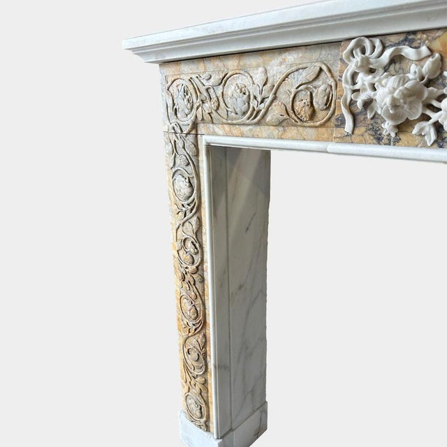 A very well carved Italian 19th century Neo Classical style fireplace in Siena and Statuary marbles. The jambs in Siena...