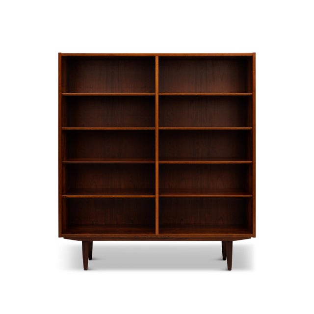 Beautiful and functional, this rare pair of Danish mid-century rosewood bookcases features rich grain and classic...