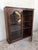 This early (circa 1830) French Provincial plantation style walnut bookcase features an upper part topped by a cornice...