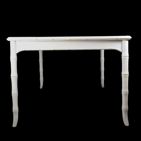 A white fretwork faux bamboo dining table, its open geometric fretwork apron giving the clean white frame wonderful...