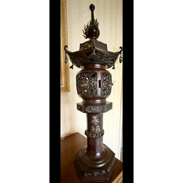 Exquisite pair of rare antique Japanese bronze “ lantern style” table lamps showing off detailed relief carvings with...