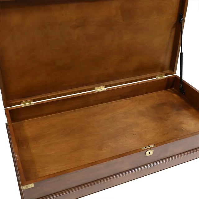 In the antique English Campaign style. The large lift top wooden coffee table provides ample storage in a unique...