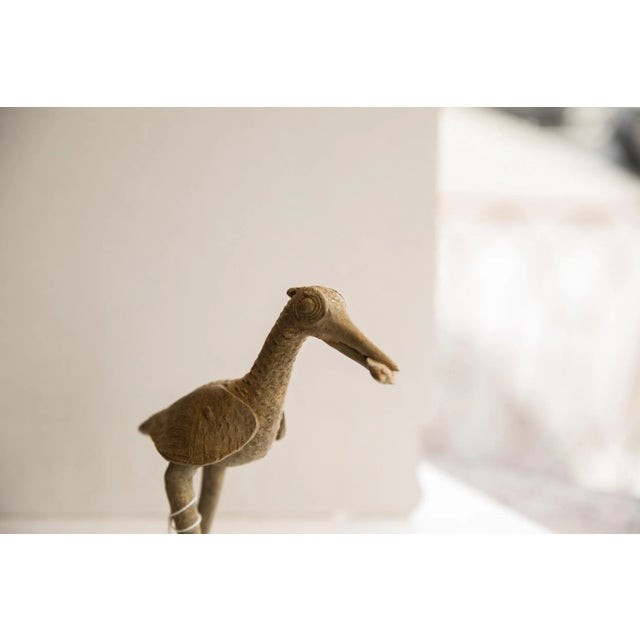 :: Vintage handmade African bird with fish sculpture. Circa late mid 20th century, though possibly older, this piece has...