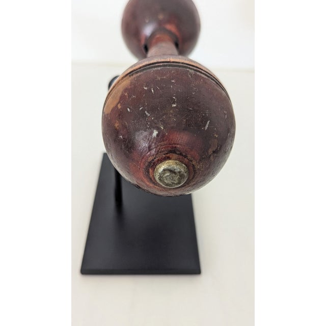 This early 20th-century wooden dumbbell has been transformed from utilitarian gym gear into a striking sculptural accent....