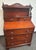 All mahogany slant front secretary desk with five drawers, bookshelves and carved drawer pulls. Front opens to a spacious...
